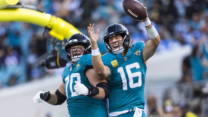 Nov 16, 2025; Jacksonville, Florida, USA; Jacksonville Jaguars quarterback Trevor Lawrence (16) celebrates with offensive tackle Cole Van Lanen (70) after rushing for a touchdown against the Los Angeles Chargers during the third quarter at EverBank Stadium. Mandatory Credit: Morgan Tencza-Imagn Images