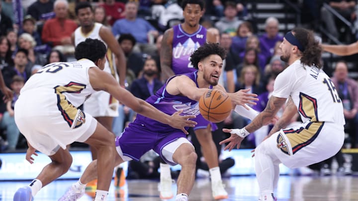 Mar 2, 2025; Salt Lake City, Utah, USA; Utah Jazz guard Johnny Juzang (33) goes for a loose ball between New Orleans Pelicans guard Trey Murphy III (25) and guard Jose Alvarado (15) during the first half at Delta Center. Mandatory Credit: Rob Gray-Imagn Images