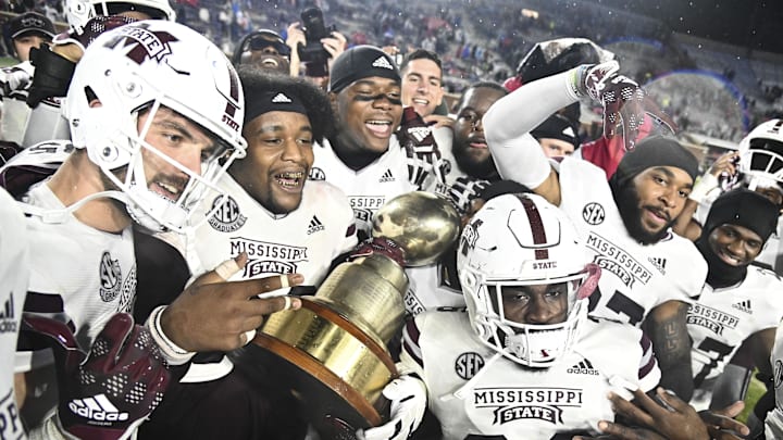Nov 24, 2022; Oxford, Mississippi, USA; Mississippi State Bulldogs players celebrate with the Egg Bowl trophy after the game against the Ole Miss Rebels at Vaught-Hemingway Stadium. 