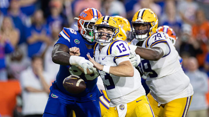 Nov 16, 2024; Gainesville, Florida, USA; Florida Gators defensive lineman Caleb Banks (88) hits LSU Tigers quarterback Garrett Nussmeier (13) to cause a fumble during the second half at Ben Hill Griffin Stadium. Mandatory Credit: Matt Pendleton-Imagn Images