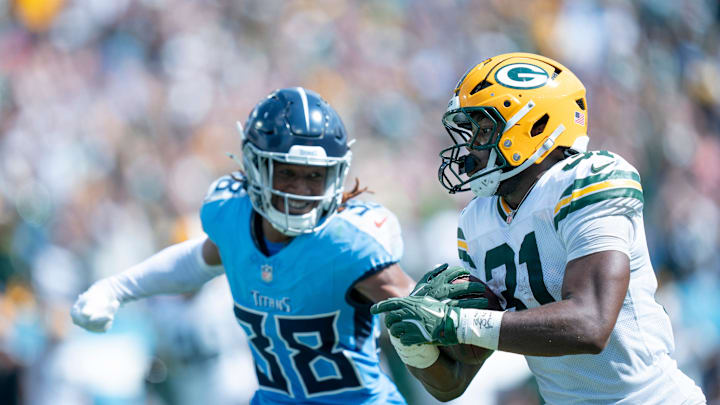 Green Bay Packers running back Emanuel Wilson outruns Tennessee Titans cornerback L'Jarius Sneed.