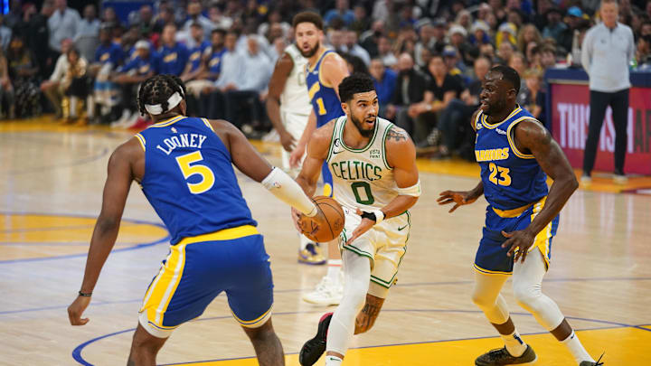 Dec 10, 2022; San Francisco, California, USA; Boston Celtics forward Jayson Tatum (0) drives past Golden State Warriors forward Draymond Green (23) in the first quarter at the Chase Center. Mandatory Credit: Cary Edmondson-Imagn Images