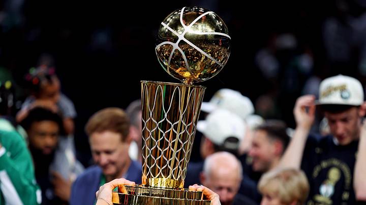 The 2023–24 Boston Celtics raise the Larry O’Brien Trophy, handed to the NBA champion each year.