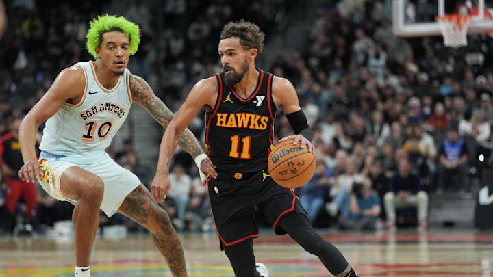 Dec 19, 2024; San Antonio, Texas, USA;  Atlanta Hawks guard Trae Young (11) dribbles against San Antonio Spurs forward Jeremy Sochan (10) in overtime at Frost Bank Center. Mandatory Credit: Daniel Dunn-Imagn Images