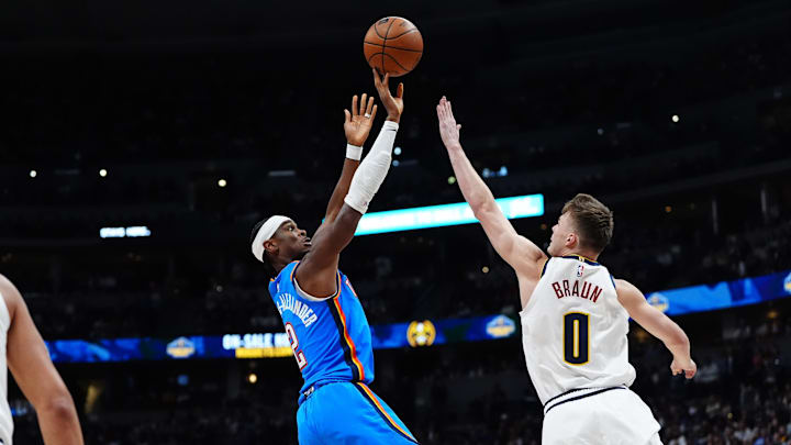 Oct 24, 2024; Denver, Colorado, USA; Oklahoma City Thunder guard Shai Gilgeous-Alexander (2) shoots the ball over Denver Nuggets guard Christian Braun (0) in the second quarter at Ball Arena. Mandatory Credit: Ron Chenoy-Imagn Images