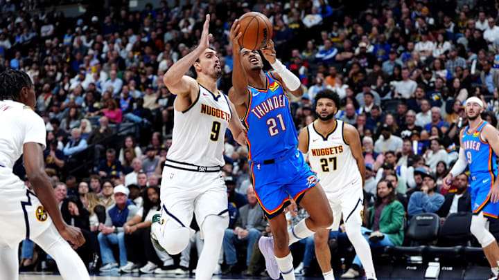 Oct 24, 2024; Denver, Colorado, USA; Denver Nuggets forward Dario Saric (9) defends on Oklahoma City Thunder guard Aaron Wiggins (21) in the second quarter at Ball Arena. Mandatory Credit: Ron Chenoy-Imagn Images