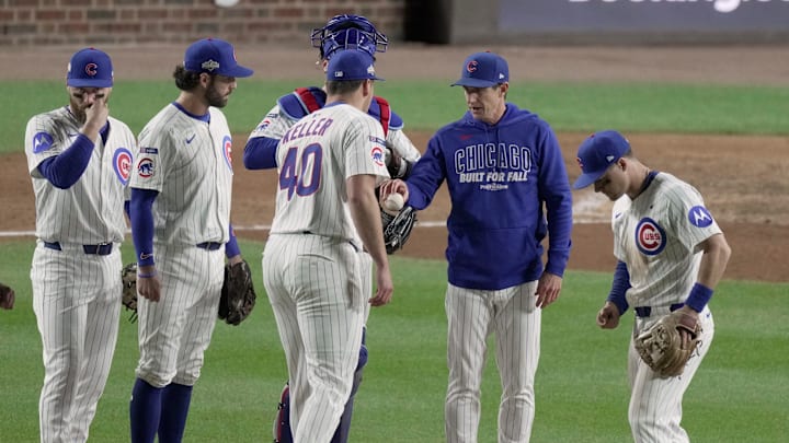 Chicago Cubs manager Craig Counsell hands to ball over to pitcher Brad Keller (40) during the eighth inning of their National League Division Series game against the Milwaukee Brewers Wednesday, October 8, 2025 at Wrigley Field in Chicago, Illinois.