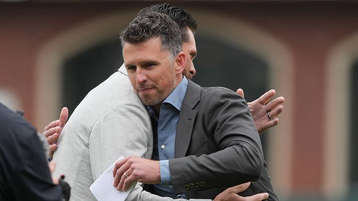 Apr 25, 2026; San Francisco, California, USA; San Francisco Giants president of baseball operations Buster Posey (right) and former first baseman Brandon Belt (left) hug before the game against the Miami Marlins at Oracle Park. Mandatory Credit: Darren Yamashita-Imagn Images