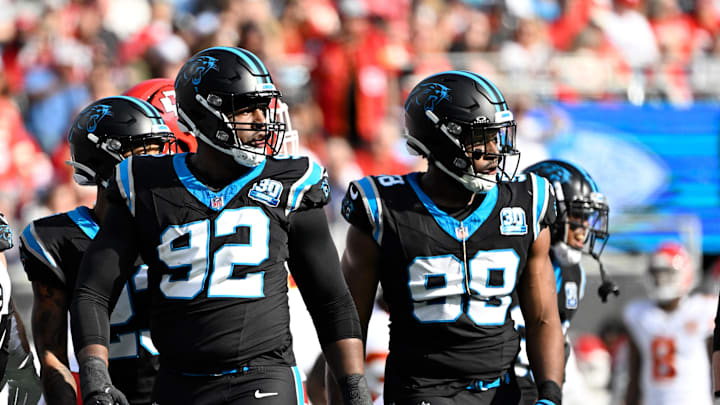 Nov 24, 2024; Charlotte, North Carolina, USA; Carolina Panthers defensive end Jonathan Harris (92) and linebacker D.J. Wonnum (98) on the field in the first quarter at Bank of America Stadium. Mandatory Credit: Bob Donnan-Imagn Images