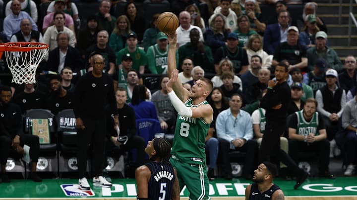 Apr 23, 2025; Boston, Massachusetts, USA; Boston Celtics center Kristaps Porzingis (8) shoots over Orlando Magic forward Paolo Banchero (5) during the first quarter of game two of the first round of the 2024 NBA Playoffs at TD Garden. Mandatory Credit: Winslow Townson-Imagn Images