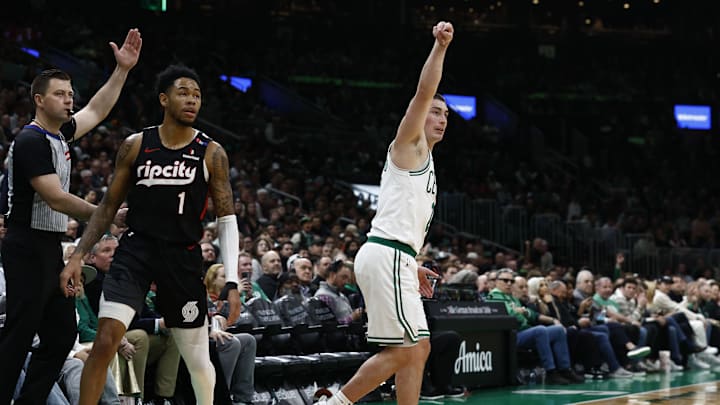 Mar 5, 2025; Boston, Massachusetts, USA; Boston Celtics guard Payton Pritchard (11) follows through on a three point basket as Portland Trail Blazers guard Anfernee Simons (1) looks on during the first quarter at TD Garden. Mandatory Credit: Winslow Townson-Imagn Images
