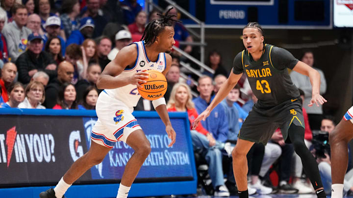 Jan 16, 2026; Lawrence, Kansas, USA; Kansas Jayhawks guard Darryn Peterson (22) dribbles the ball as Baylor Bears guard Cameron Carr (43) defends during the first half of the game at Allen Fieldhouse. Mandatory Credit: Denny Medley-Imagn ImagesAC