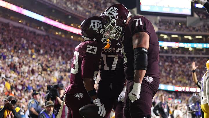 Oct 25, 2025; Baton Rouge, Louisiana, USA; Texas A&M Aggies running back Jamarion Morrow (23) celebrates with offensive lineman Chase Bisontis (71) and tight end Theo Melin Ohrstrom (17) after a touchdown during the second half against the Louisiana State Tigers at Tiger Stadium. Mandatory Credit: Stephen Lew-Imagn Images