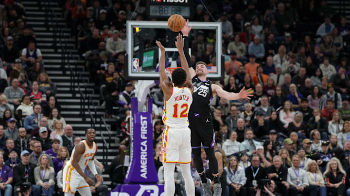 Jan 7, 2025; Salt Lake City, Utah, USA;  Utah Jazz center Micah Potter (25) tries to block the shot of Atlanta Hawks forward De'Andre Hunter (12) during the second half at Delta Center. Mandatory Credit: Chris Nicoll-Imagn Images