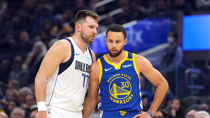 Dec 15, 2024; San Francisco, California, USA; Dallas Mavericks guard Luka Doncic (77) talks to Golden State Warriors guard Stephen Curry (30) during the first quarter at Chase Center. Mandatory Credit: Darren Yamashita-Imagn Images