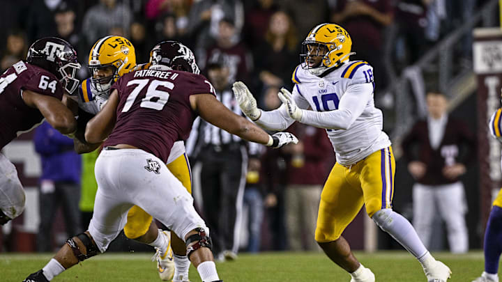 Nov 26, 2022; College Station, Texas, USA; Texas A&M Aggies offensive lineman Reuben Fatheree II (76) and LSU Tigers defensive end BJ Ojulari (18) in action during the game between the Texas A&M Aggies and the LSU Tigers at Kyle Field. Mandatory Credit: Jerome Miron-Imagn Images