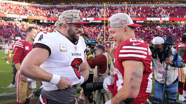 Nov 19, 2023; Santa Clara, California, USA; Tampa Bay Buccaneers quarterback Baker Mayfield (left) and San Francisco 49ers running back Christian McCaffrey (right) talk after the game at Levi's Stadium. Mandatory Credit: Darren Yamashita-Imagn Images