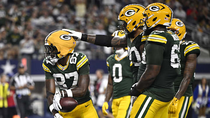 Green Bay Packers receiver Romeo Doubs (87) celebrates with teammates after scoring a touchdown against the Dallas Cowboys. Green Bay Packers receiver Romeo Doubs (87) celebrates with teammates after scoring a touchdown against the Dallas Cowboys.