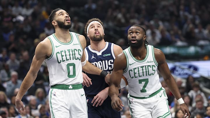 Tatum and Brown look for a rebound against Mavericks guard Klay Thompson.