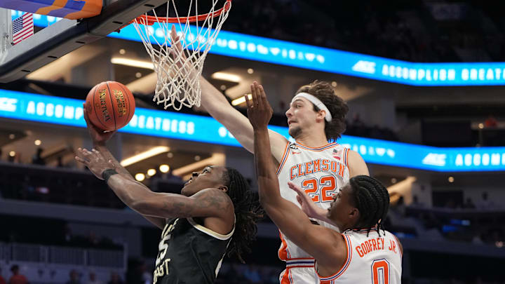 Mar 11, 2026; Charlotte, NC, USA; Wake Forest Demon Deacons forward Tre'von Spillers (25) shoots as Clemson Tigers center Carter Welling (22) and forward RJ Godfrey (0) defend in the first half at Spectrum Center. Mandatory Credit: Bob Donnan-Imagn Images