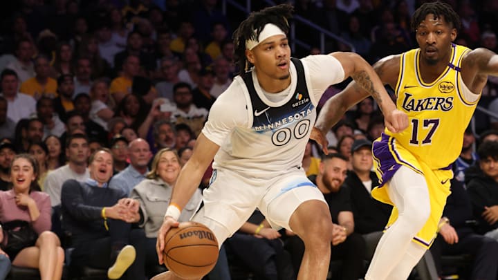 Feb 27, 2025; Los Angeles, California, USA; Minnesota Timberwolves guard Terrence Shannon Jr. (00) drives against Los Angeles Lakers forward Dorian Finney-Smith (17) during the third quarter at Crypto.com Arena. Mandatory Credit: Jason Parkhurst-Imagn Images
