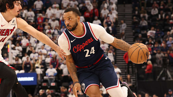 Jan 13, 2025; Inglewood, California, USA; LA Clippers guard Norman Powell (24) drives against Miami Heat guard Jaime Jaquez Jr. (11) during the second quarter at Intuit Dome. Mandatory Credit: Jason Parkhurst-Imagn Images