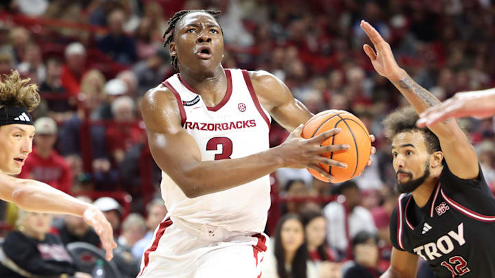 Nov 13, 2024; Fayetteville, Arkansas, USA; Arkansas Razorbacks forward Adou Thiero (3) drives to the basket in the second half asTroy Trojans guard Tayton Conway (12) defends at Bud Walton Arena. Arkansas won 65-49. Mandatory Credit: Nelson Chenault-Imagn Images Nov 13, 2024; Fayetteville, Arkansas, USA; Arkansas Razorbacks forward Adou Thiero (3) drives to the basket in the second half asTroy Trojans guard Tayton Conway (12) defends at Bud Walton Arena. Arkansas won 65-49. Mandatory Credit: Nelson Chenault-Imagn Images
