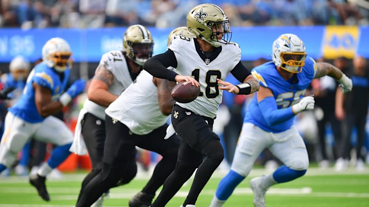 Oct 27, 2024; Inglewood, California, USA; New Orleans Saints quarterback Spencer Rattler (18) runs out to pass against the Los Angeles Chargers during the first half at SoFi Stadium. Mandatory Credit: Gary A. Vasquez-Imagn Images
