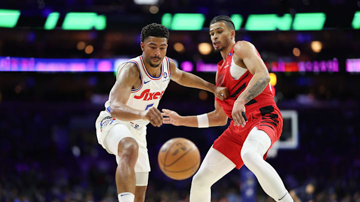 Mar 3, 2025; Philadelphia, Pennsylvania, USA; Philadelphia 76ers guard Quentin Grimes (5) reaches for a loose ball in front of Portland Trail Blazers forward Toumani Camara (33) during the first quarter at Wells Fargo Center. Mandatory Credit: Bill Streicher-Imagn Images