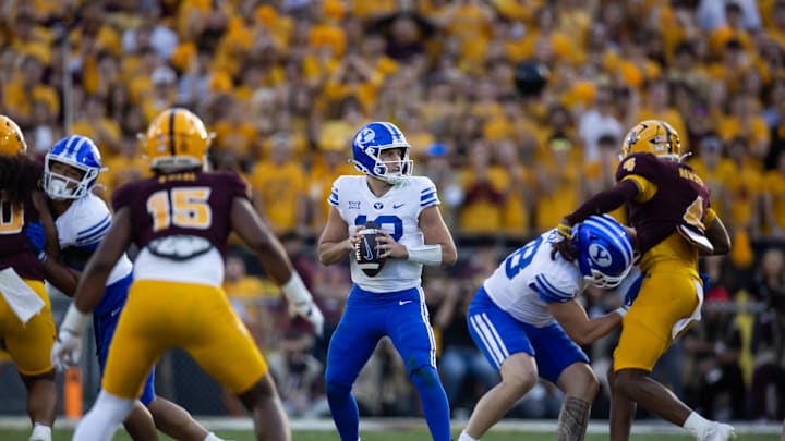 Nov 23, 2024; Tempe, Arizona, USA; Brigham Young Cougars quarterback Jake Retzlaff (12) against the Arizona State Sun Devils at Mountain America Stadium. Mandatory Credit: Mark J. Rebilas-Imagn Images