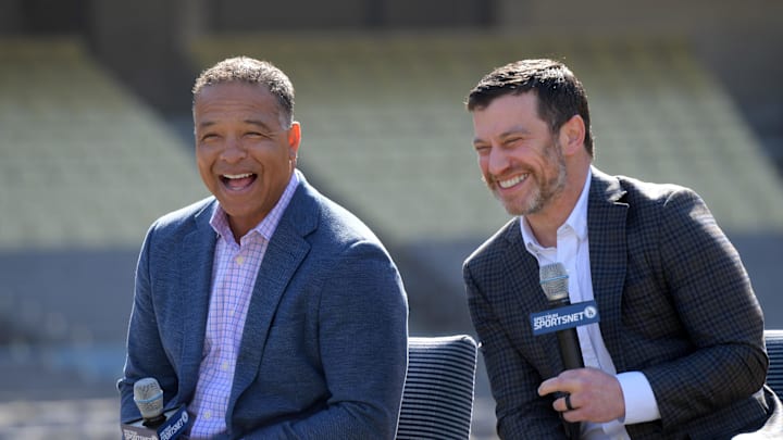 Feb 12, 2020; Los Angeles, California, USA; Los Angeles Dodgers manager Dave Roberts (left) and president of baseball operations Andrew Friedman react during a press conference at Dodger Stadium. Mandatory Credit: Kirby Lee-Imagn Images