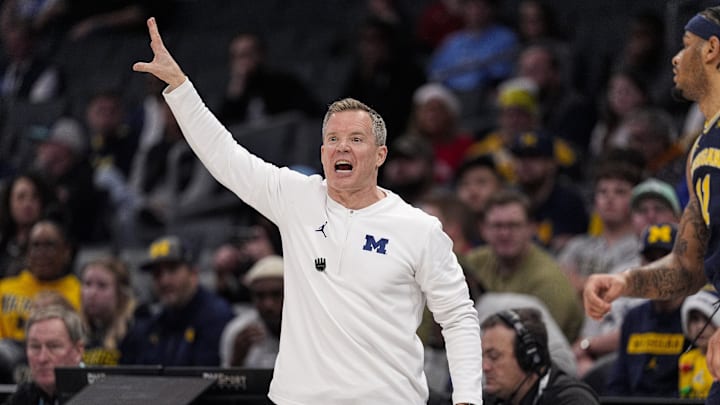 Dec 18, 2024; Charlotte, North Carolina, USA; Michigan Wolverines head coach Dusty May yells to his team during the first half against the Oklahoma Sooners at Spectrum Center. Mandatory Credit: Jim Dedmon-Imagn Images