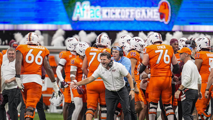 Aug 31, 2025; Atlanta, Georgia, USA; Virginia Tech Hokies head coach Brent Pry reacts with players after a fifty-six yard field goal against the South Carolina Gamecocks on the final play of the first half at Mercedes-Benz Stadium. Mandatory Credit: Dale Zanine-Imagn Images