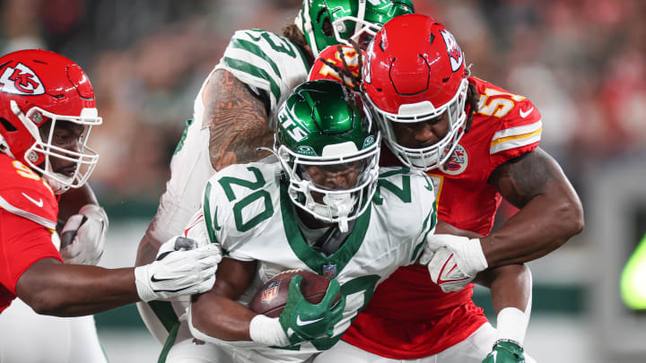 Oct 1, 2023; East Rutherford, New Jersey, USA; New York Jets running back Breece Hall (20) is tackled by Kansas City Chiefs defensive end Mike Danna (51) during the first half at MetLife Stadium. 