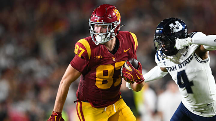 Sep 7, 2024; Los Angeles, California, USA; USC Trojans tight end Lake McRee (87) runs the ball against Utah State Aggies cornerback D.J. Graham II (4) during the second quarter at United Airlines Field at Los Angeles Memorial Coliseum. Mandatory Credit: Jonathan Hui-Imagn Images