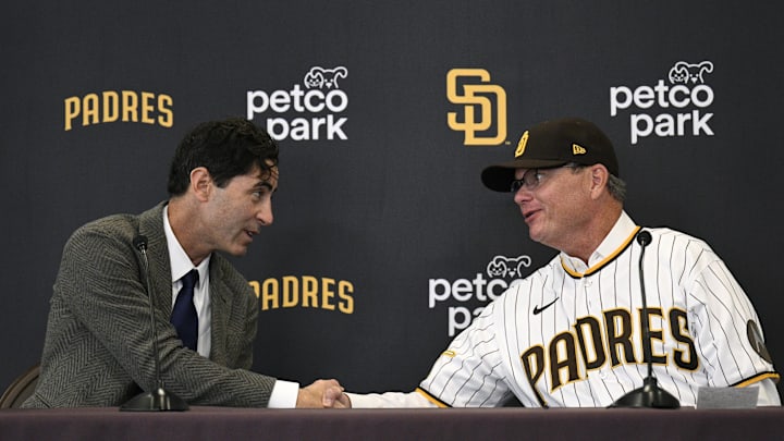 Nov 21, 2023; San Diego, CA, USA; San Diego Padres manager Mike Shildt (right) shakes hands with president of baseball operations and general manager A.J. Preller during a press conference announcing the hiring of Shildt at Petco Park. Mandatory Credit: Orlando Ramirez-Imagn Images