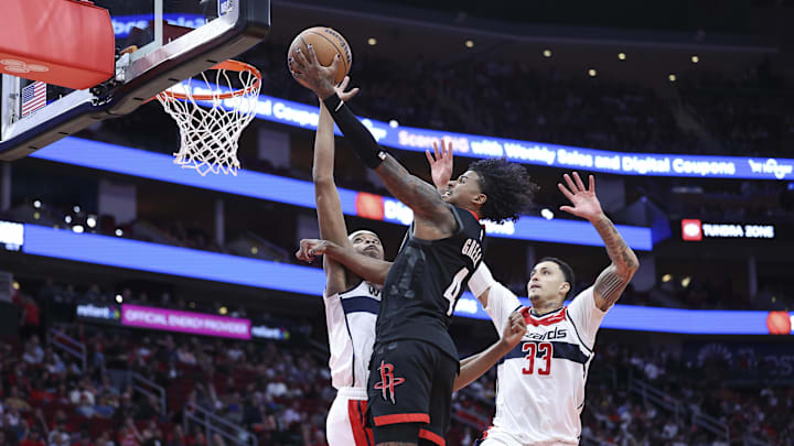 Mar 14, 2024; Houston, Texas, USA; Houston Rockets guard Jalen Green (4) drives to the basket as Washington Wizards guard Bilal Coulibaly (0) defends during the second quarter at Toyota Center. Mandatory Credit: Troy Taormina-Imagn Images