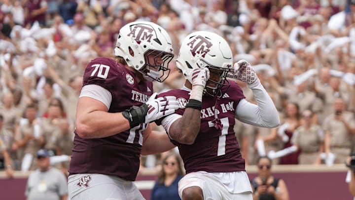 Sep 6, 2025; College Station, Texas, USA; Texas A&M Aggies offensive lineman Robert Bourdon (70) and wide receiver KC Concepcion (7) celebrate after a touchdown during the second half against the Utah State Aggies at Kyle Field. Mandatory Credit: Sean Thomas-Imagn Images
