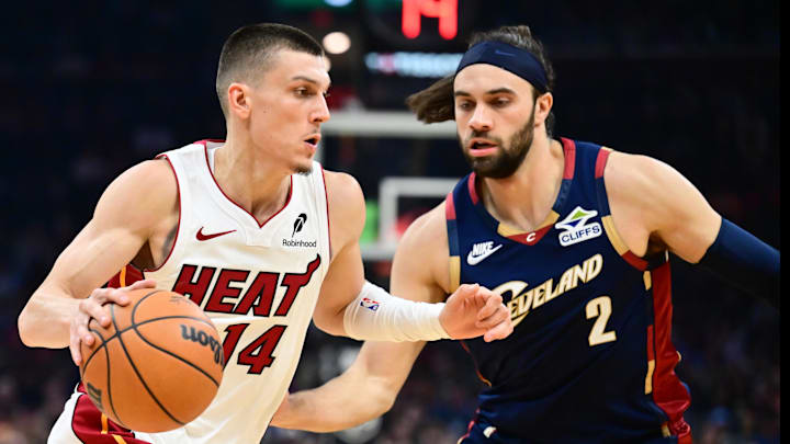 Mar 27, 2026; Cleveland, Ohio, USA; Miami Heat guard Tyler Herro (14) drives to the basket against Cleveland Cavaliers guard Max Strus (2) during the first half at Rocket Arena. Mandatory Credit: Ken Blaze-Imagn Images