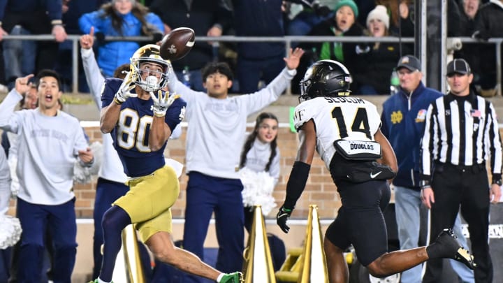 Nov 18, 2023; South Bend, Indiana, USA; Notre Dame Fighting Irish wide receiver Jordan Faison (80) catches a pass for a touchdown in front of Wake Forest Demon Deacons defensive back Evan Slocum (14) in the fourth quarter at Notre Dame Stadium. Mandatory Credit: Matt Cashore-USA TODAY Sports Nov 18, 2023; South Bend, Indiana, USA; Notre Dame Fighting Irish wide receiver Jordan Faison (80) catches a pass for a touchdown in front of Wake Forest Demon Deacons defensive back Evan Slocum (14) in the fourth quarter at Notre Dame Stadium. Mandatory Credit: Matt Cashore-USA TODAY Sports