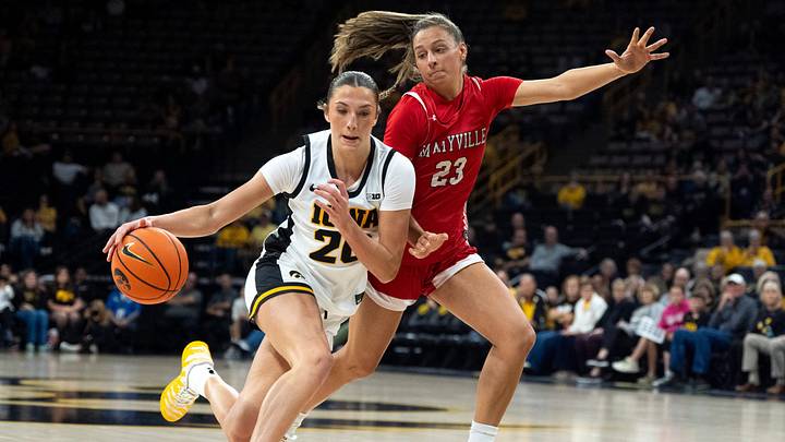 Iowa forward McKenna Woliczko (20) dribbles toward the basket against Maryville’s Lindsey Schadewalt (23) Oct. 29, 2026 during an exhibition game at Carver-Hawkeye Arena in Iowa City, Iowa.