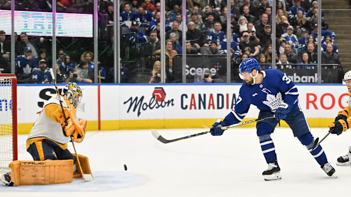 Jan 11, 2023; Toronto, Ontario, CAN; Nashville Predators goaltender Jusse Saros (74) stops a shot from Toronto Maple Leafs defenseman Timothy Liljegren (37) in the first period at Scotiabank Arena. Mandatory Credit: Dan Hamilton-USA TODAY Sports