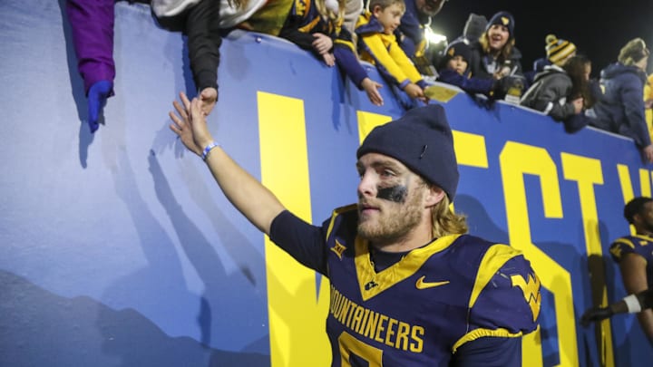 Nov 23, 2024; Morgantown, West Virginia, USA; West Virginia Mountaineers quarterback Garrett Greene (6) celebrates with fans after defeating the UCF Knights at Mountaineer Field at Milan Puskar Stadium. Mandatory Credit: Ben Queen-Imagn Images