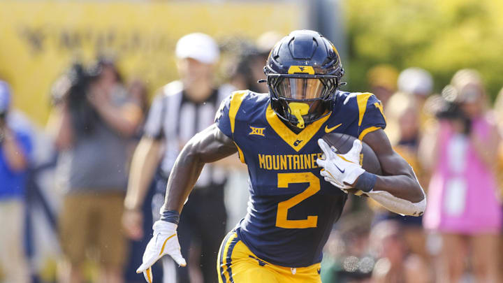 Sep 13, 2025; Morgantown, West Virginia, USA; West Virginia Mountaineers running back Tye Edwards (2) runs the ball during the second quarter against the Pittsburgh Panthers at Milan Puskar Stadium. Mandatory Credit: Ben Queen-Imagn Images
