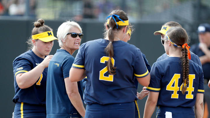 Michigan coach Bonnie Tholl talks with her team during a softball game against Kentucky during first