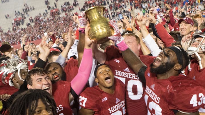 Oct 1, 2016; Bloomington, IN, USA; Indiana Hoosiers offensive lineman Jacob Bailey (70) and linebacker Dameon Willis Jr. (43) and other teammates hoist the brass spittoon in victory after the game against the Michigan State Spartans at Memorial Stadium. Indiana Hoosiers beat the Michigan State Spartans by the score of 24-21. Mandatory Credit: Trevor Ruszkowski-Imagn Images