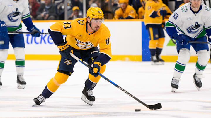 Jan 29, 2025; Nashville, Tennessee, USA;  Nashville Predators defenseman Adam Wilsby (83) skates with the puck against the Vancouver Canucks during the first period at Bridgestone Arena. Mandatory Credit: Steve Roberts-Imagn Images