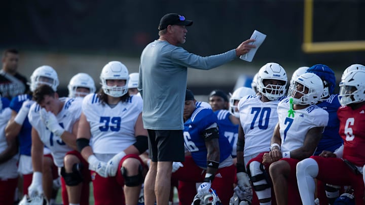 Kansas coach Lance Leipold talks to players during an outdoor practice on July 30, 2025.
