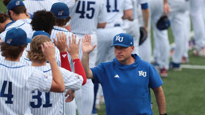 Kansas Jayhawks coach Dan Fitzgerald high fives players before taking on Oklahoma Sooners during the NCAA Lawrence Super Regional game at Hoglund Ballpark on June 6, 2026. Kansas Jayhawks coach Dan Fitzgerald high fives players before taking on Oklahoma Sooners during the NCAA Lawrence Super Regional game at Hoglund Ballpark on June 6, 2026.