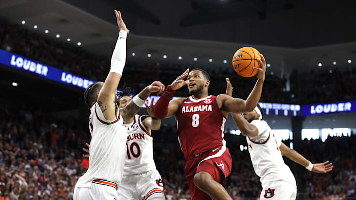 Mar 8, 2025; Auburn, Alabama, USA;  Alabama Crimson Tide guard Chris Youngblood (8) goes for a shot against Auburn Tigers forward Johni Broome (4) during the first half at Neville Arena. Mandatory Credit: John Reed-Imagn Images